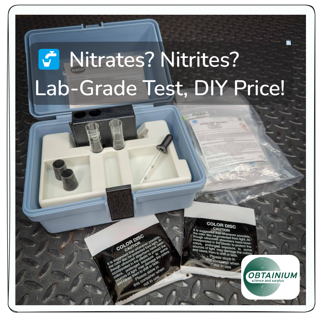 Hach Water Test Kit for Nitrites and Nitrates from Obtainium Science and Surplus, displayed open on a textured metal surface. The blue plastic case contains glass test tubes, black caps, a dropper, and compartments for reagents. Instruction sheets and reagent packets are visible.